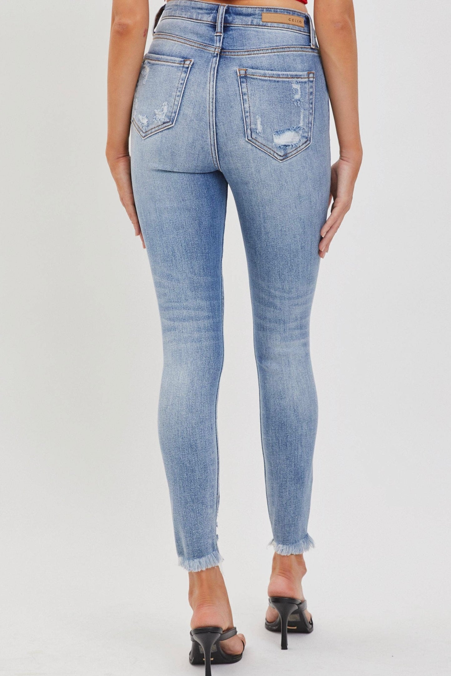 Back view of Cello high rise skinny jeans med wash distressed hem