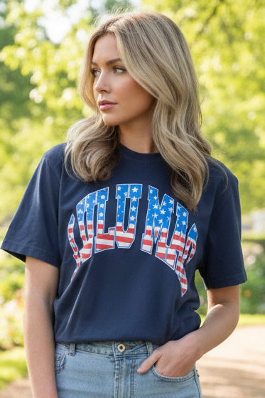 Woman wearing a navy blue t-shirt with 'Merica design outdoors