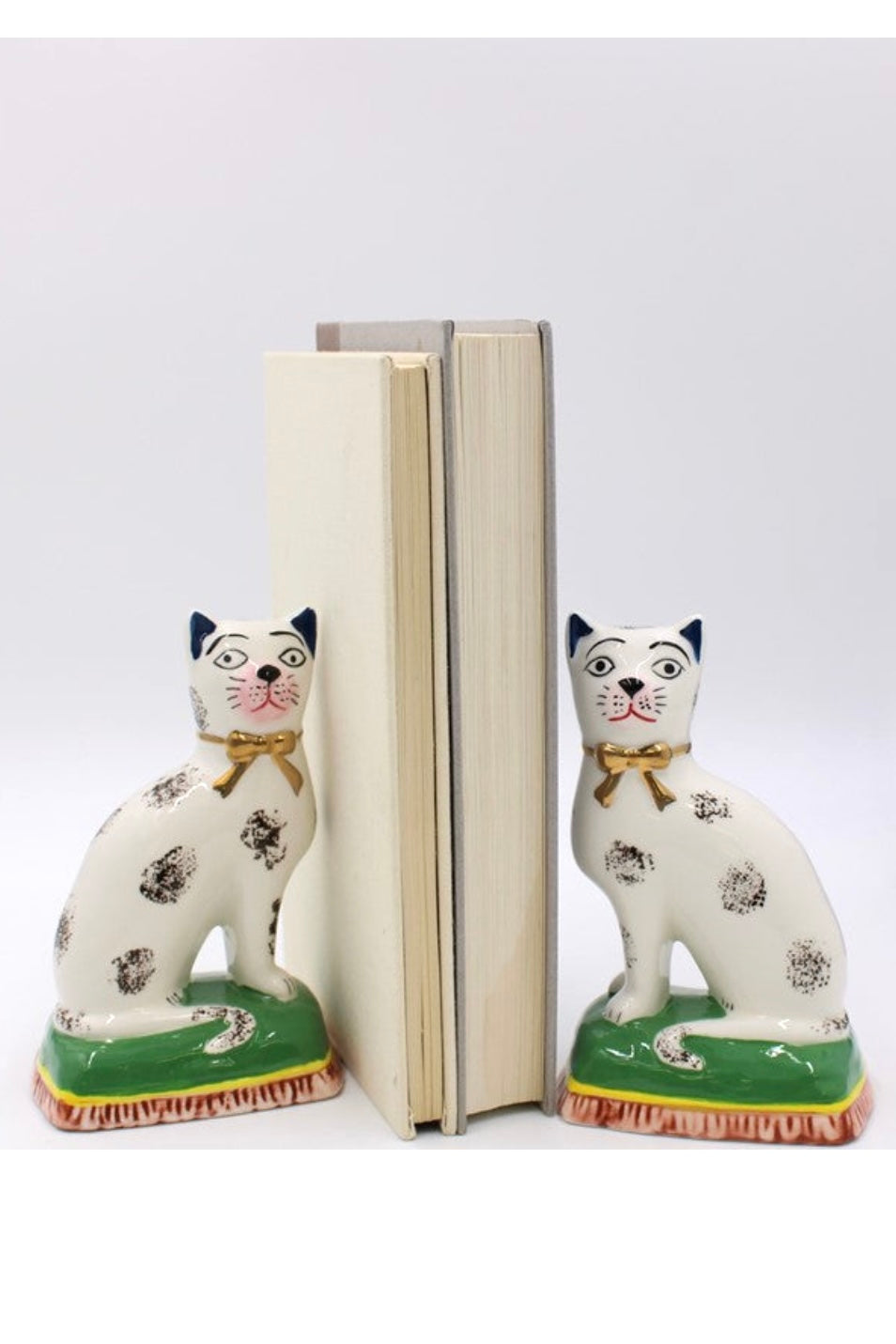 Cat-shaped figurines on a white background