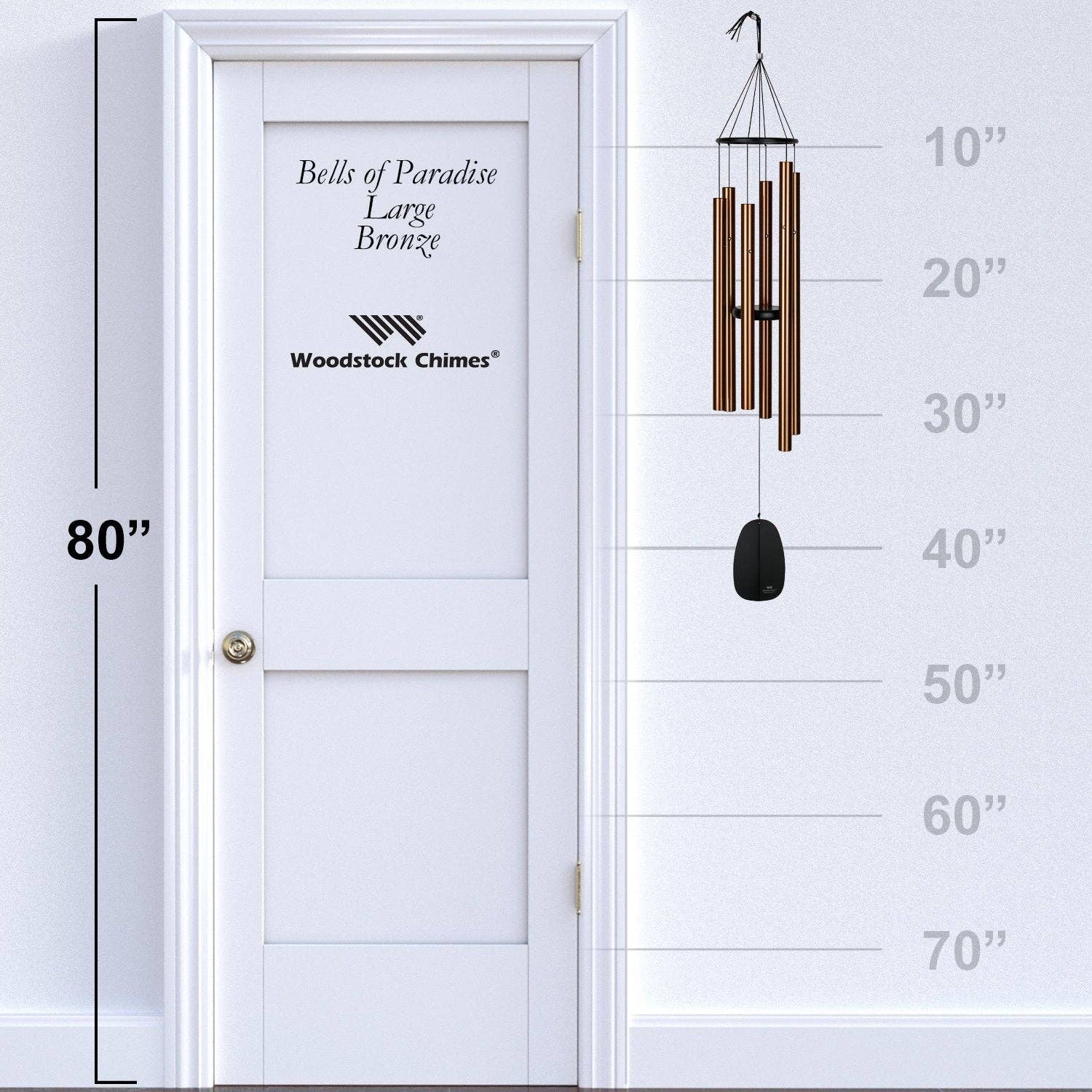 Woodstock Chimes wind chime next to a door with measurement scale