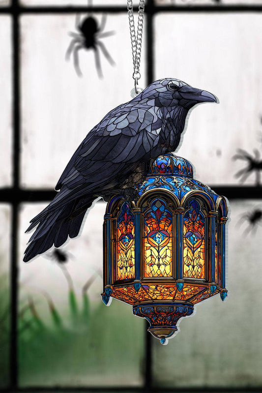 Decorative stained glass look lantern with a bird on top, spider webs in the background