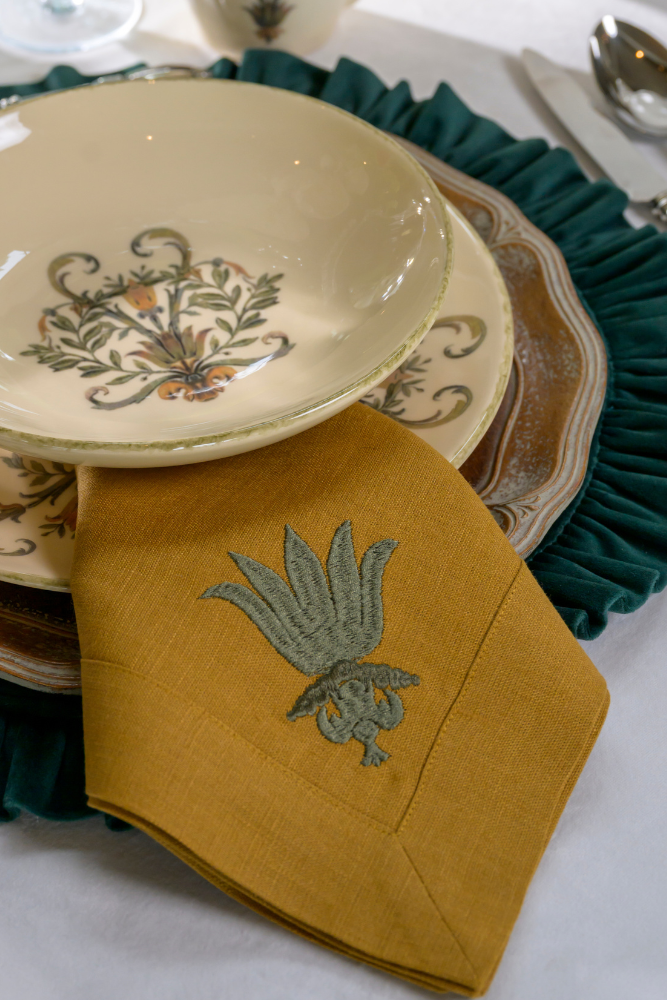 Decorative table setting with patterned plates and napkin on a white surface