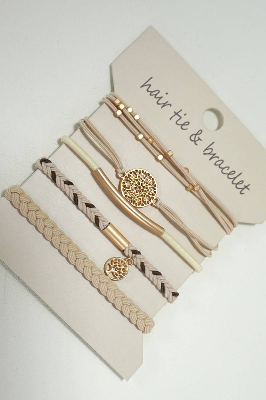 Set of hair ties and bracelets on a branded card with a white background