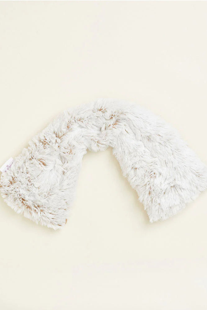 Cream fluffy neck wrap on a light beige background