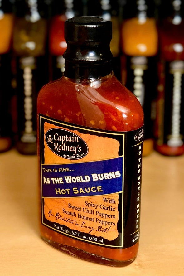 Bottle of Captain Rodney's 'As the World Burns' hot sauce with a blurred background of other bottles.