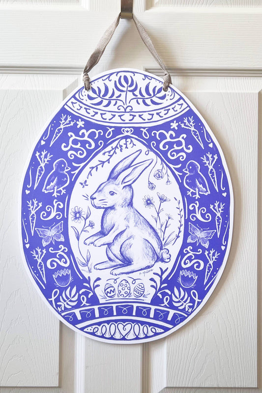 Decorative door hanger with a rabbit design on a white wooden door