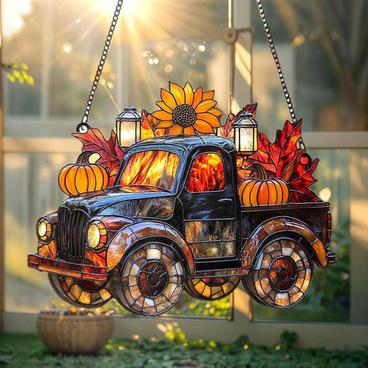 Decorative stained glass truck with autumn elements hanging outdoors.