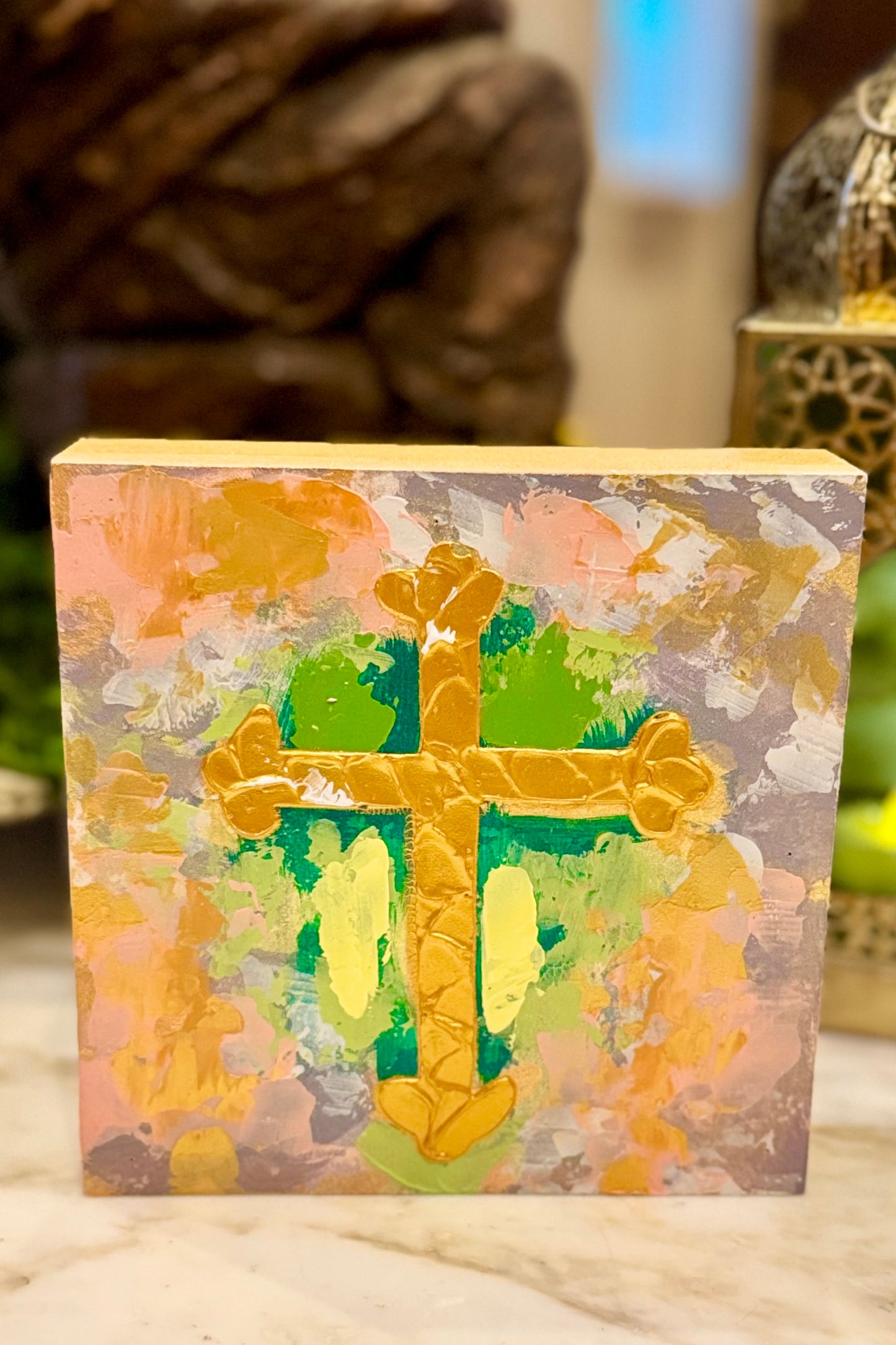 Decorative block with a cross design on a floral background