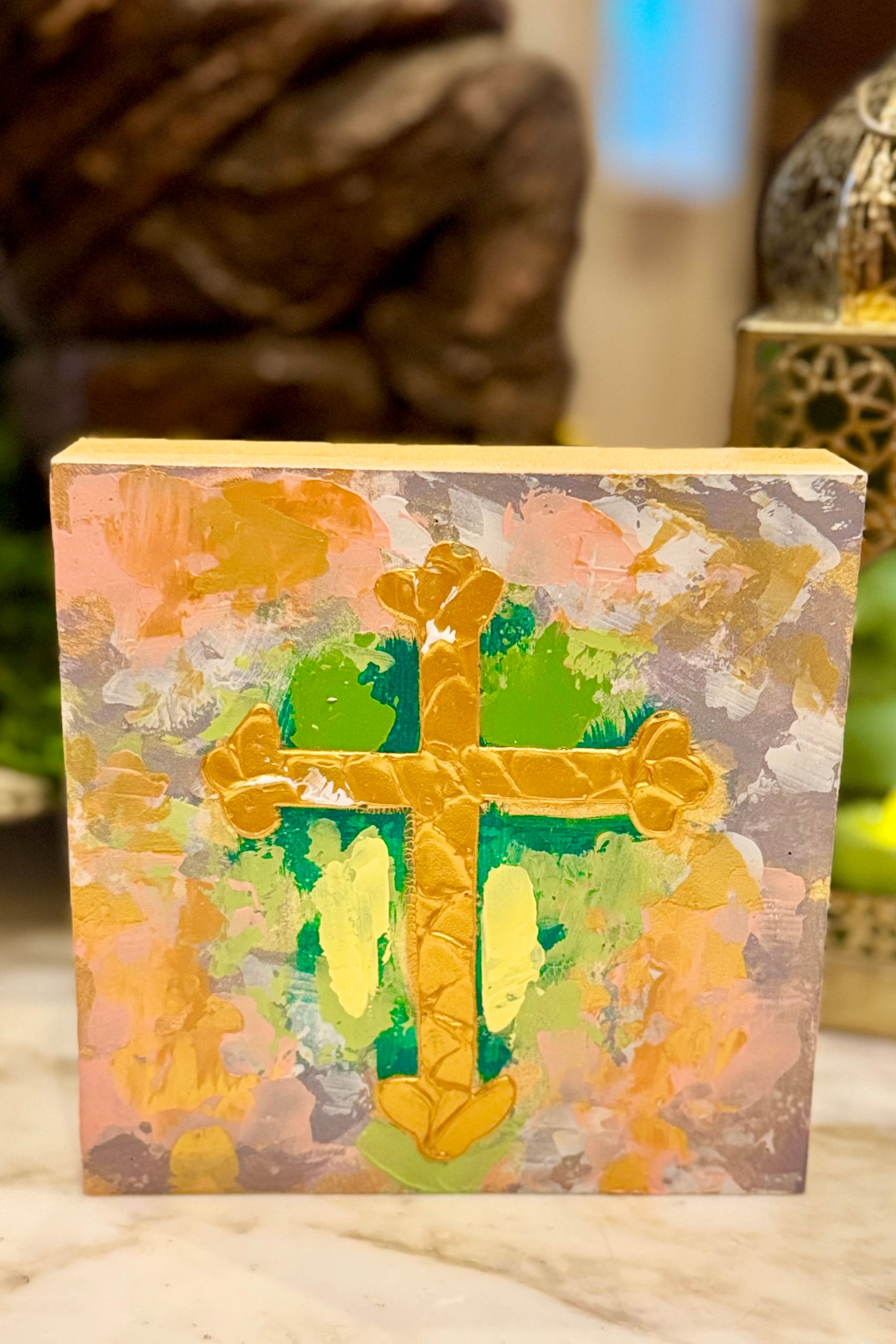 Decorative block with a cross design on a floral background