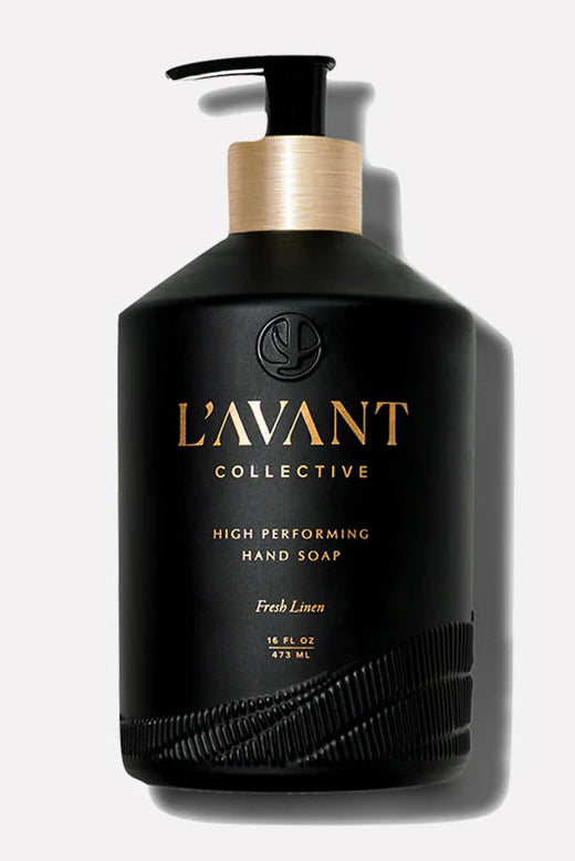 Black hand soap bottle with gold pump and 'L'Avant Collective' branding on a white background