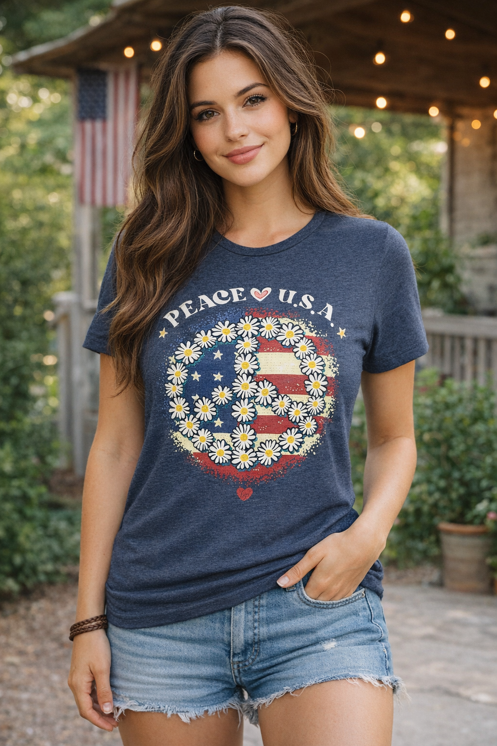 Woman wearing a blue t-shirt with 'PEACE U.S.A' design outdoors.