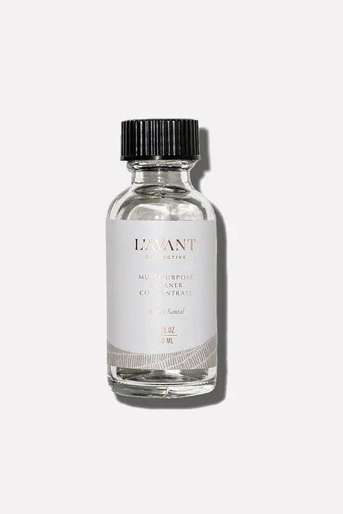 Clear glass bottle with black cap on a white background.  L'Avant Ambre Santal Multipurpose Cleaner Concentrate Refill