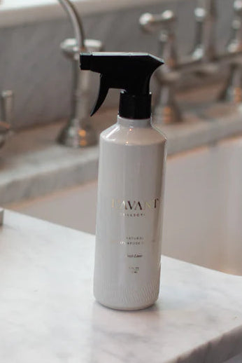 White spray bottle with black nozzle on a kitchen counter