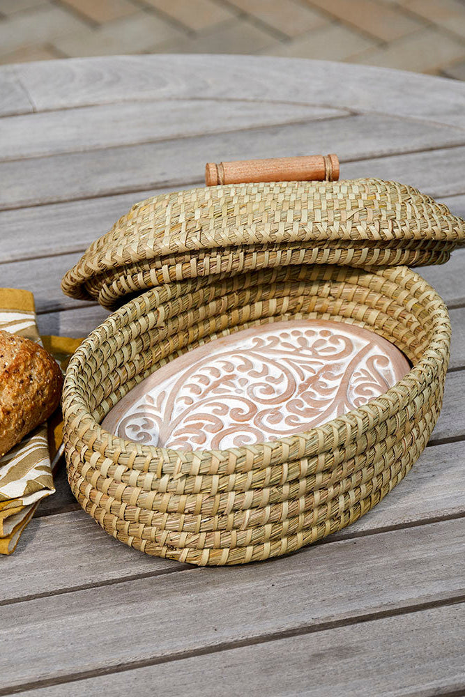 Woven bread basket with a loaf of bread on a wooden surface