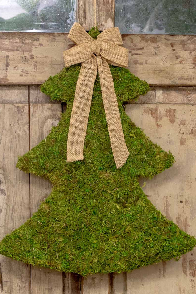 Moss-covered Christmas tree decoration with a burlap bow on a wooden background