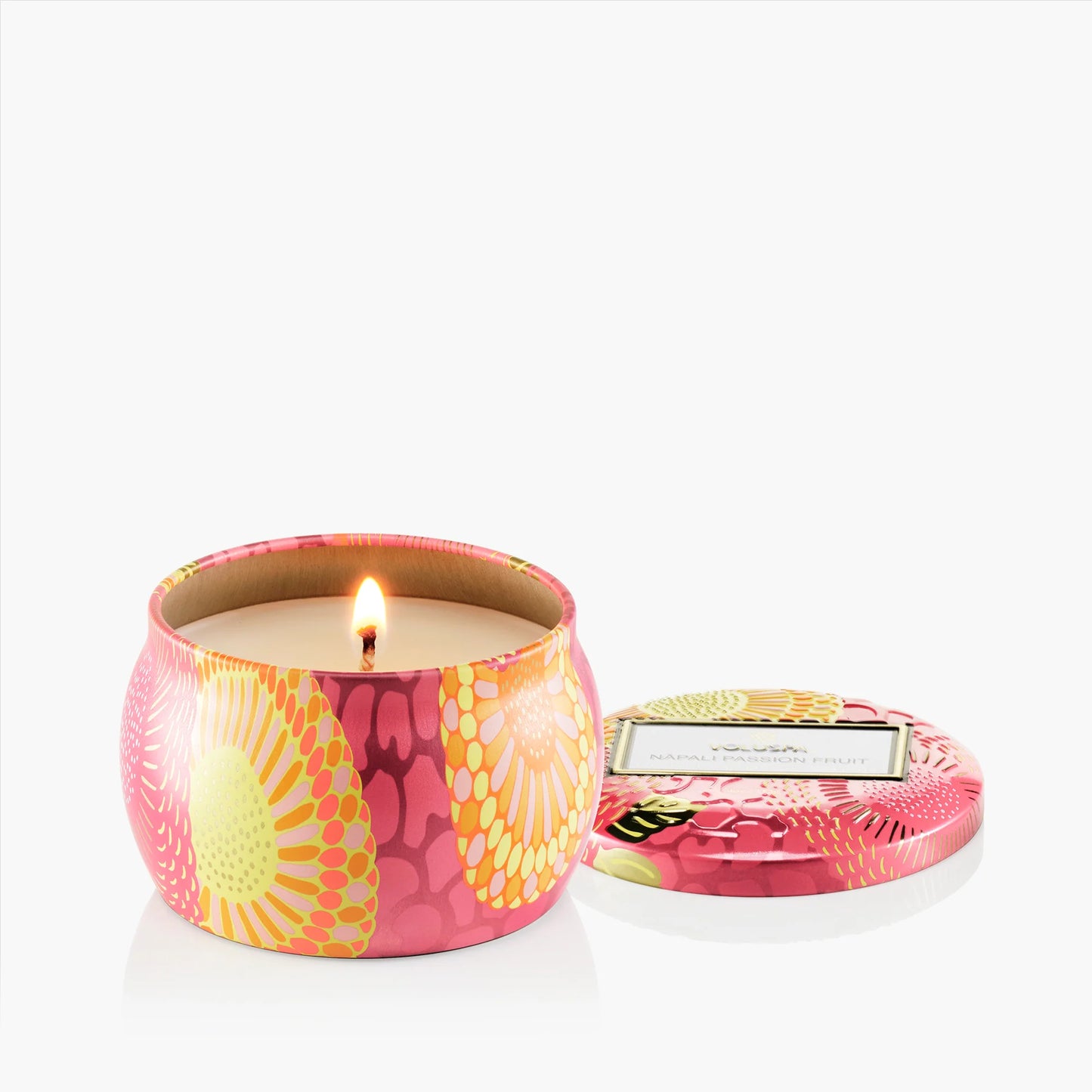 Floral-patterned candle in a tin with lid on a white background