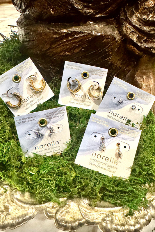 Narelle earrings on display with a decorative background