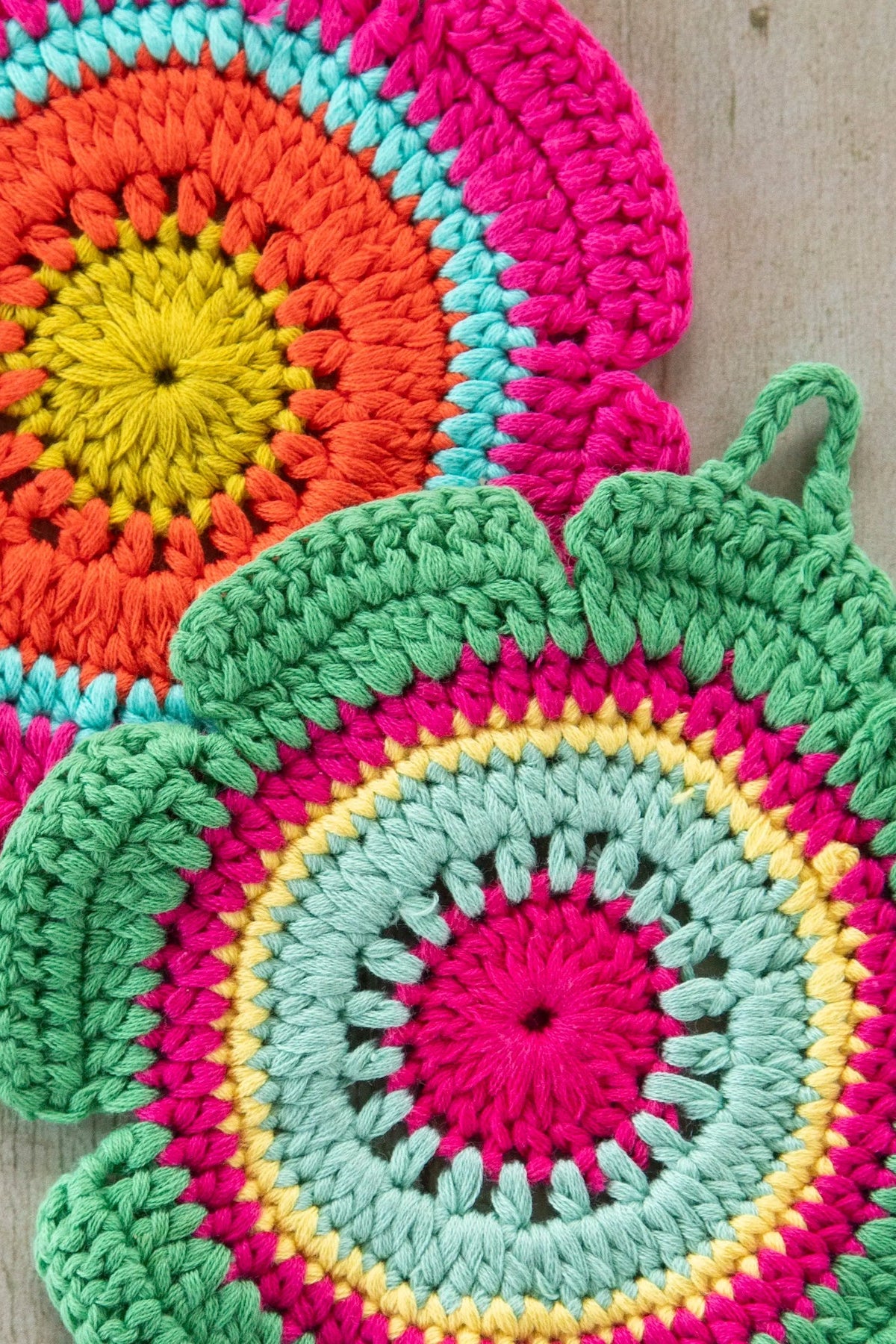 Colorful crocheted trivets  on a wooden surface