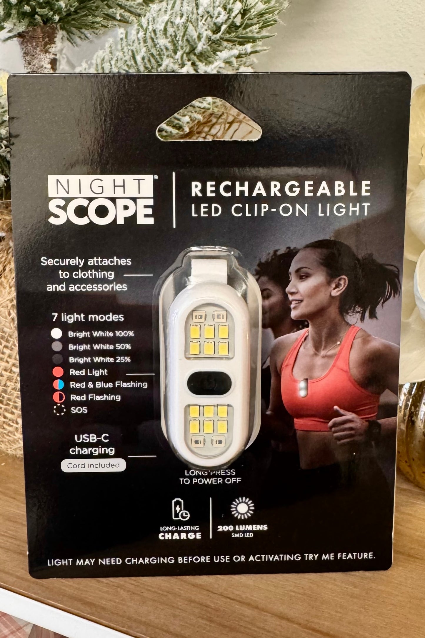 Packaging of Night Scope rechargeable LED clip-on light with product image and features.