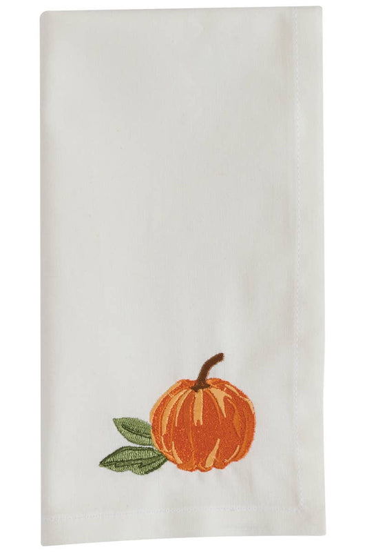 White towel with an embroidered orange pumpkin and green leaves on a white background