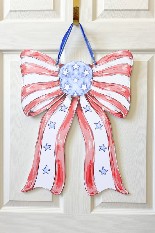 Decorative bow with American flag design on a white door