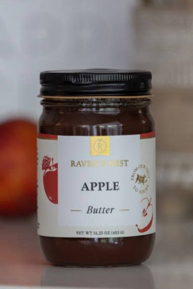 Jar of apple butter with a blurred background