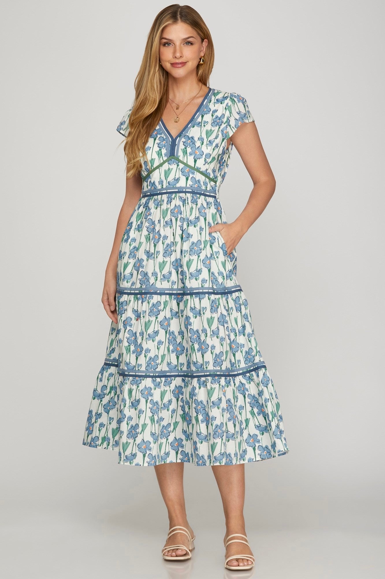 Woman wearing a floral dress on a plain background