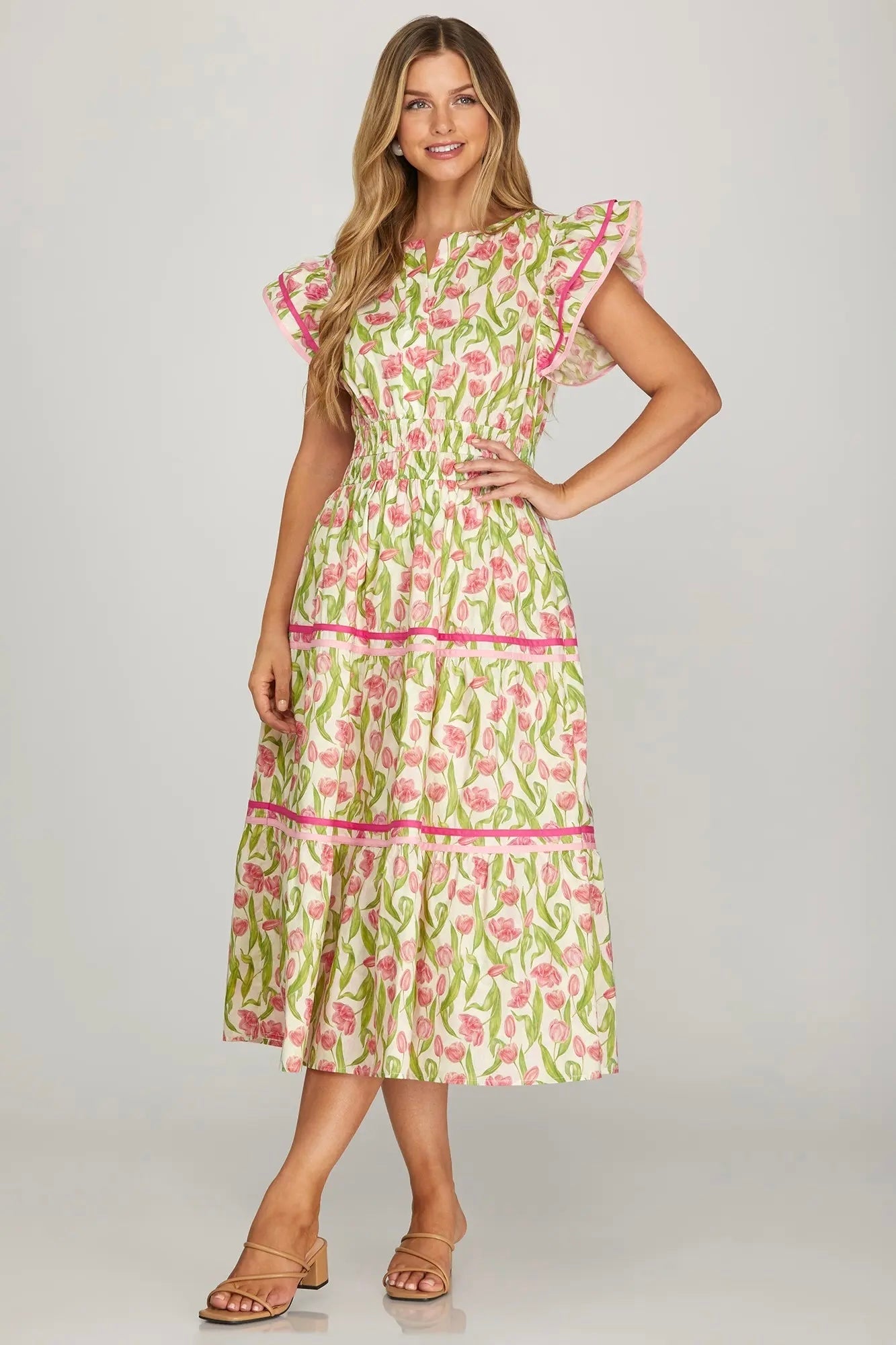 Woman wearing a floral dress on a plain background