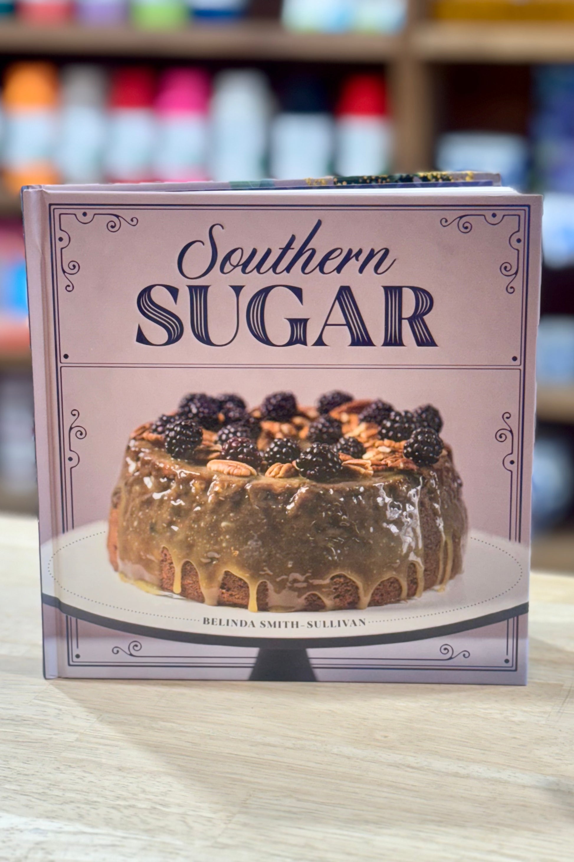 Book titled 'Southern Sugar' with a cake illustration on the cover, placed on a surface.