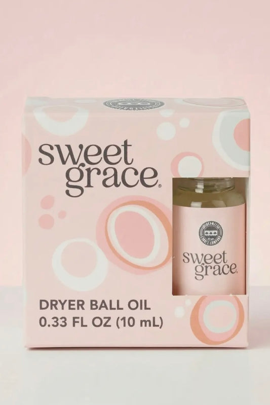 Sweet Grace dryer ball oil packaging on a light pink background