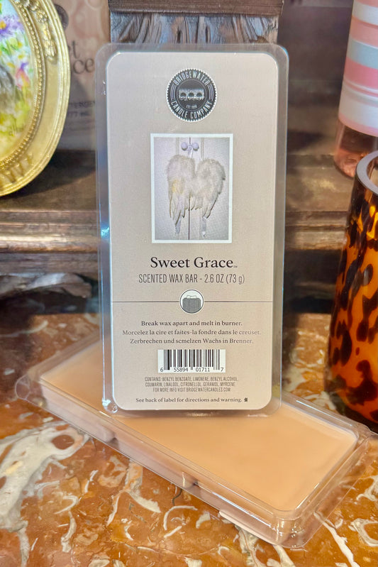Scented wax bar with packaging labeled 'Sweet Grace' on a decorative surface.