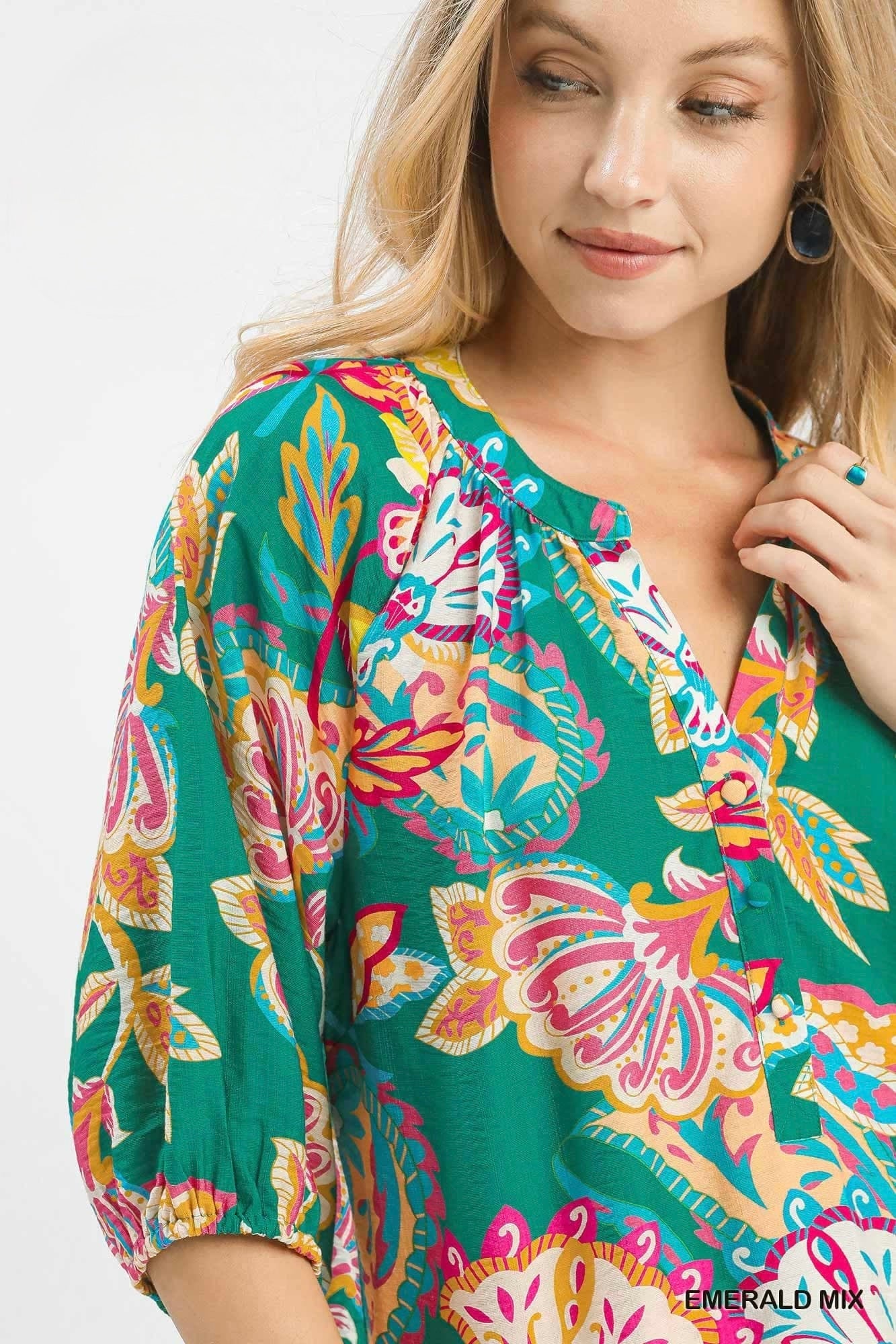 Woman wearing a colorful floral dress with a white background