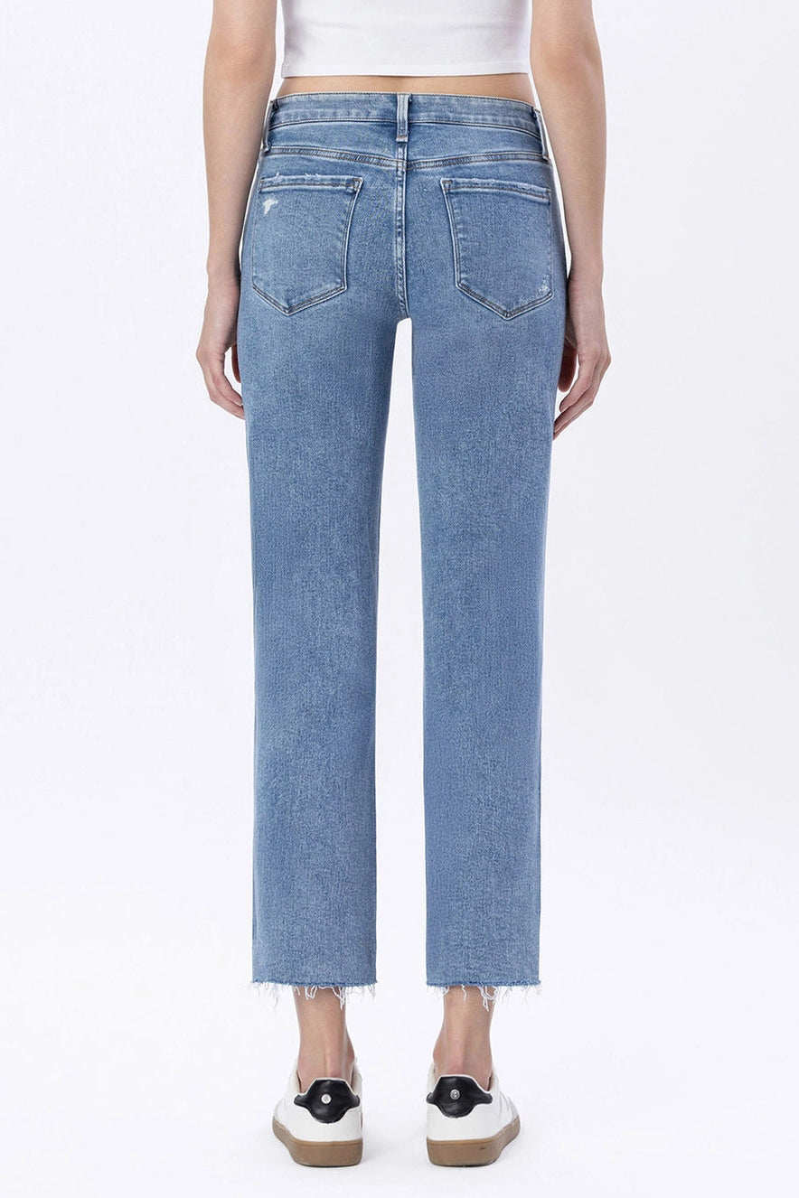 Person wearing light blue jeans on a white background