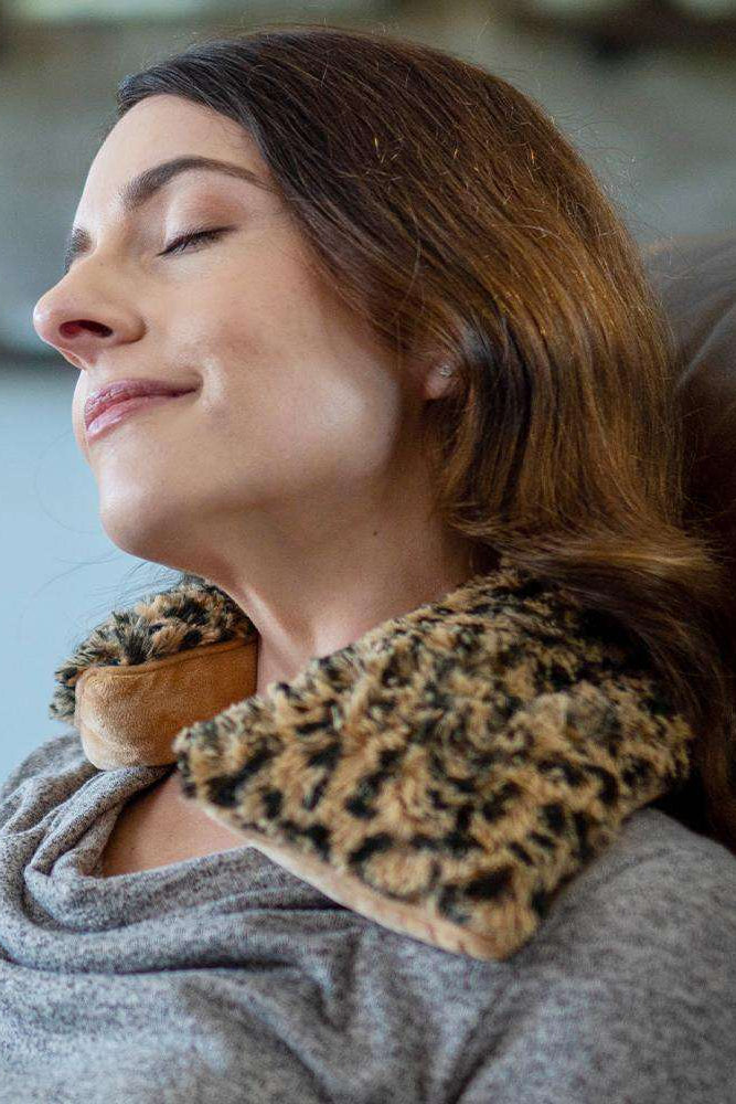 Woman wearing a leopard print neck wrap with a blurred background