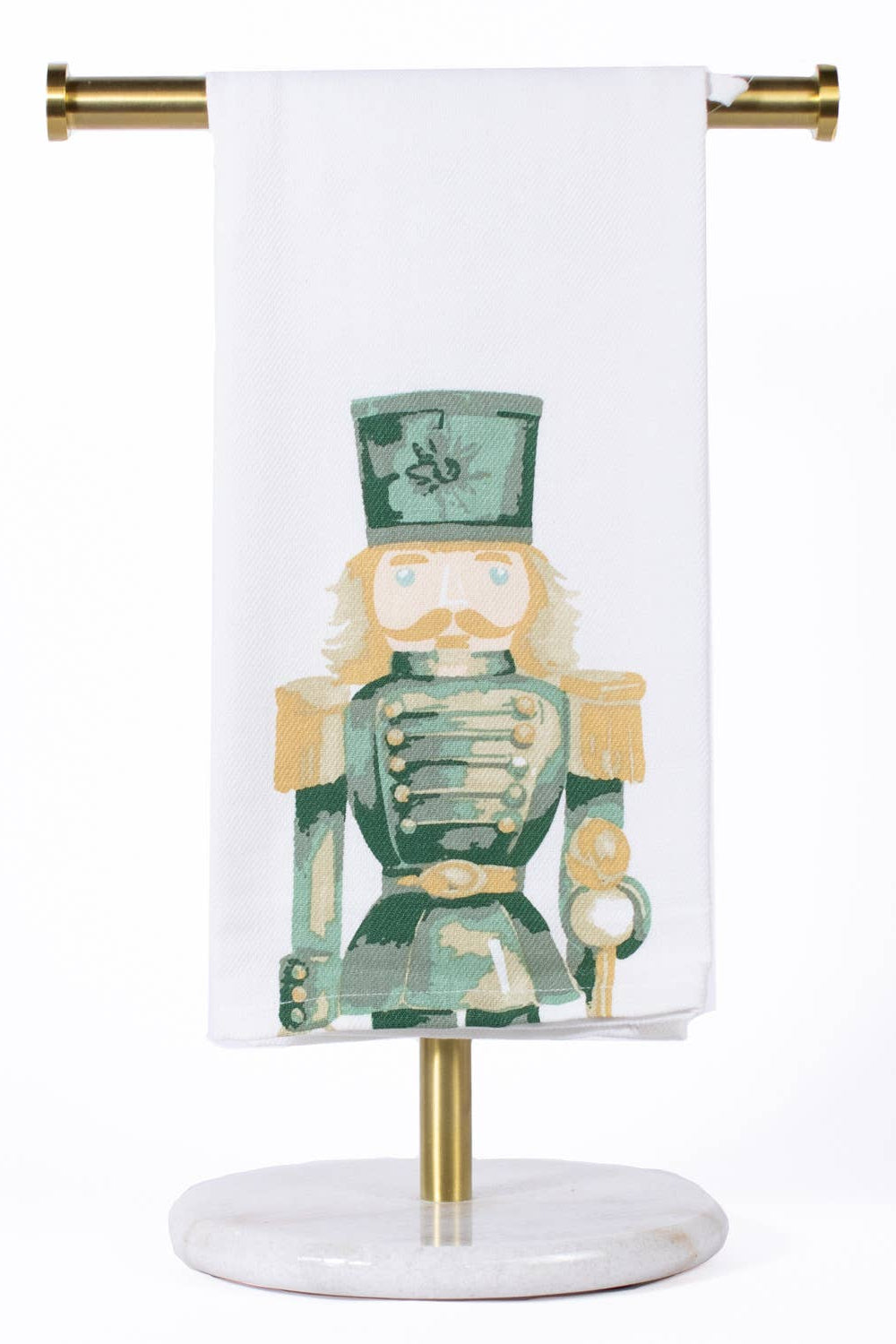 Towel with nutcracker design on a stand against a white background