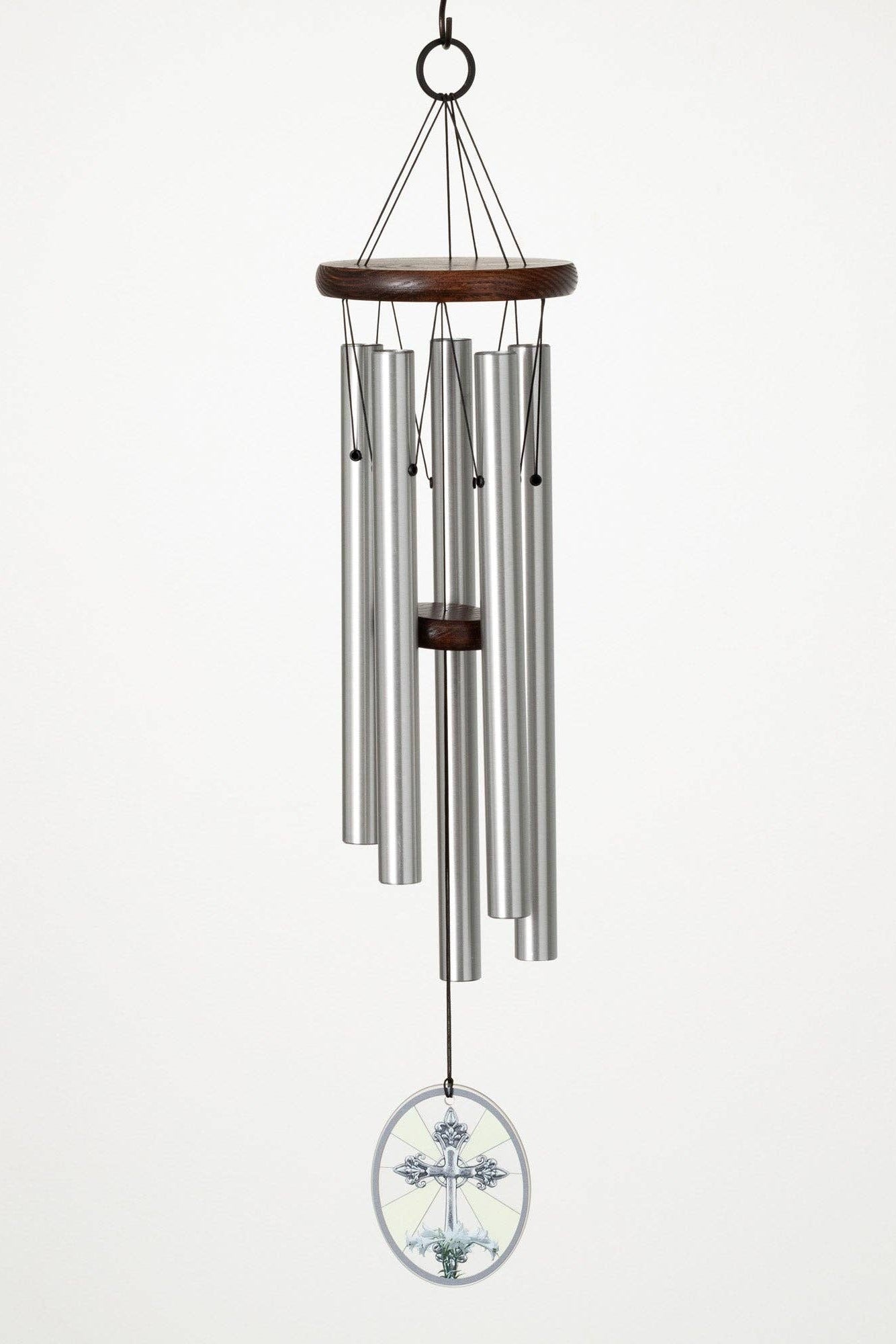 Memorial wind chime with lily and cross, metal tubes and wooden top on a white background