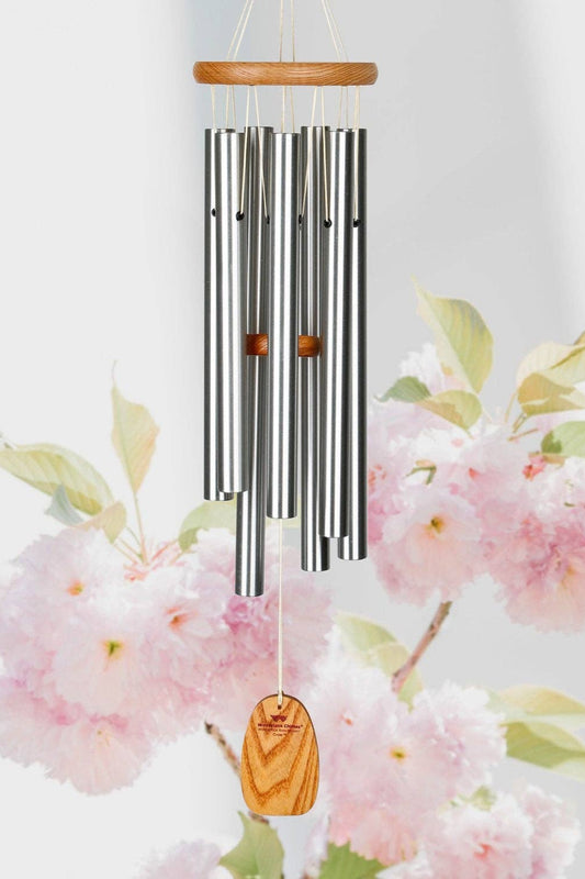Decorative wind chime with cherry blossoms in the background