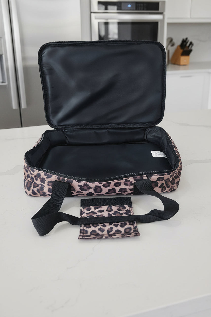 Black food carrier with leopard print base and handle on a white background