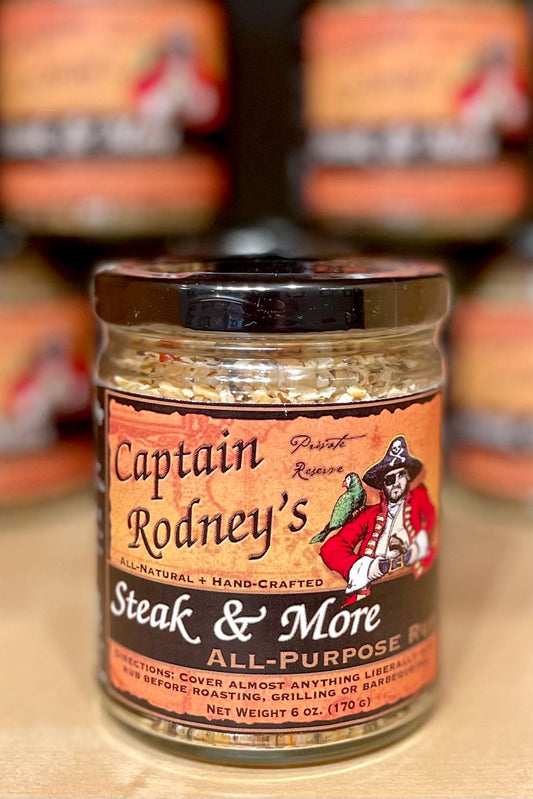 Jar of Captain Rodney's Steak & More All-Purpose Rub with blurred jars in the background