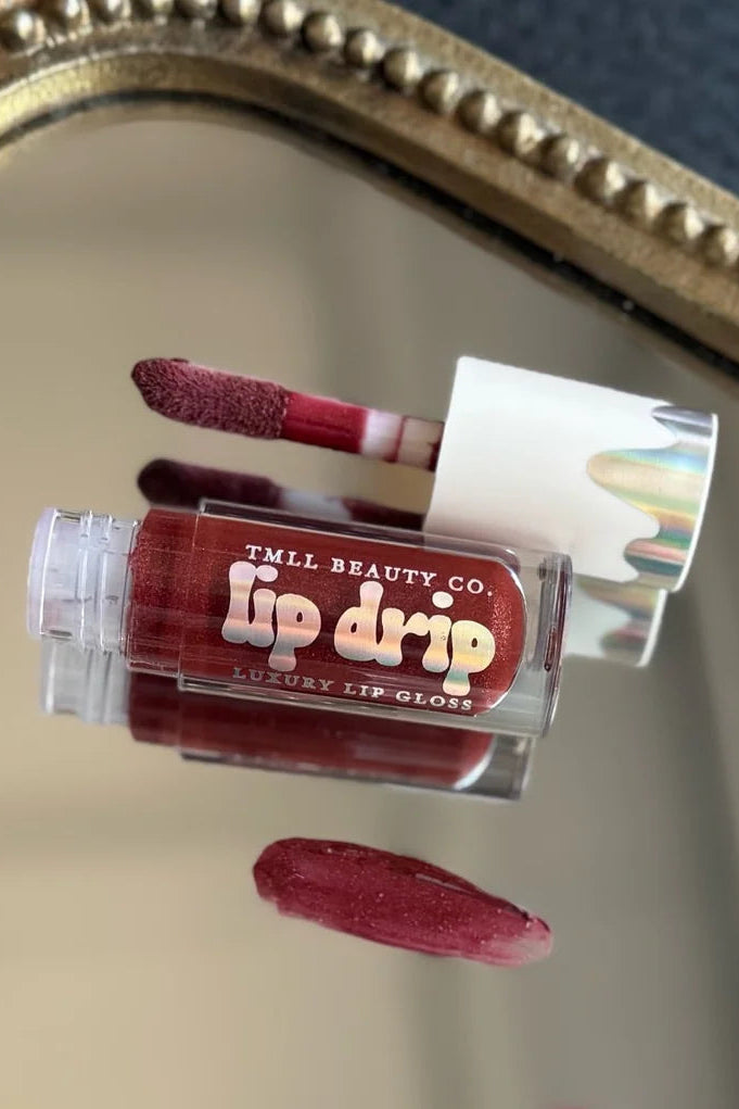 TMLL Beauty Co. lip gloss with a mirror background.  frosted cherry lip drip